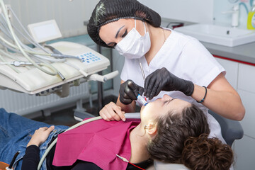 Stomatology and tooth care. Dentistry and oral health. Woman have teeth examination at dentistry clinic. Closeup young caucasian girl face.