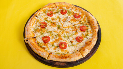 Pizza top view isolated on yellow background
