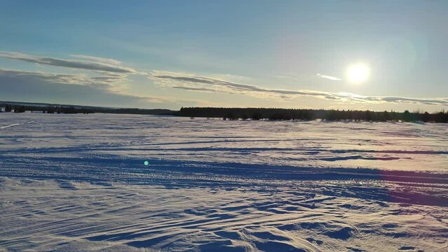 winter panorama in field, field and sun