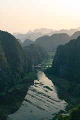 Viewpoint Đầm sen Hang múa is a popular spot for tourists visiting Tam Coc in the Ninh Binh region of Vietnam. In the background are the mountains and rice fields of the region. - obrazy, fototapety, plakaty