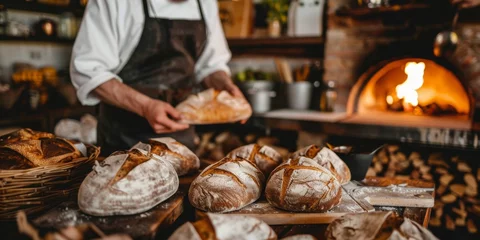 Poster Rustic bread baking in a cozy kitchen with a baker pulling freshly baked artisan loaves from a stone oven surrounded by ingredients © Shutter2U