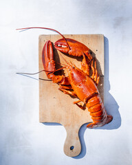 Lobster on a Wooden Plate, Resting on a Marble Table.