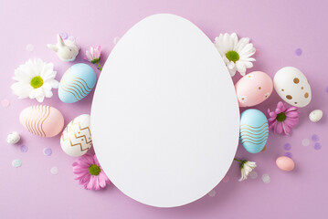 Chic Easter theme setup: Overhead shot of pastel eggs, porcelain rabbit, daisies, and confetti...