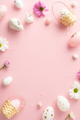 Fototapeta na wymiar Festive Easter composition inspiration: Top view vertical photo capturing speckled eggs, tiny baskets, rabbit statuettes, daisies over soft pink background, with space reserved for custom greetings