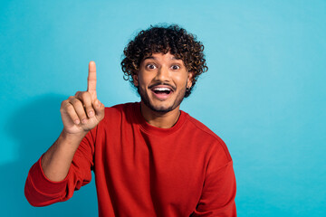 Closeup photo of funny mexican wavy hair man in red pullover point finger you finger up genius idea...