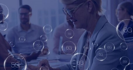 Animation of 6g texts over caucasian businesswoman using tablet - Powered by Adobe