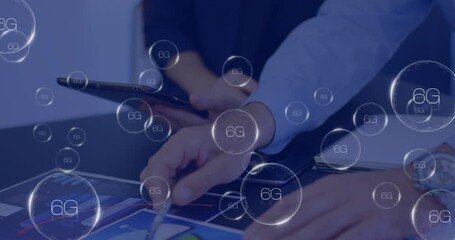 Animation of 6g texts over caucasian business people discussing work - Powered by Adobe