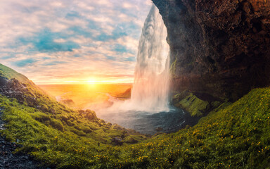 Fototapeta na wymiar Landscape of sunset shine through Seljalandsfoss waterfall flowing in summer at Iceland