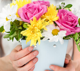 bouquet of flowers in female hands close-up