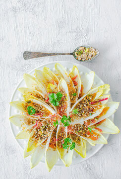 Chicory with nuts, onion and orange dressing