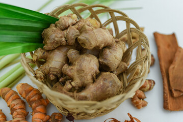 ginger, cinnamon, turmeric, galangal, pandan leaves, lemongrass on a white background