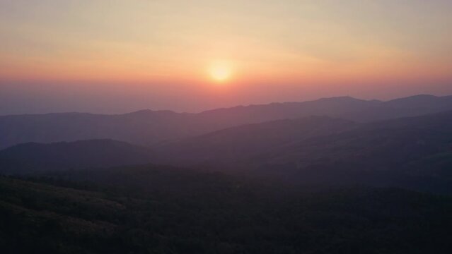 Colorful sunrise over mountain range in tropical rainforest at Phu Lom Lo, Phu Hin Rong Kla national park
