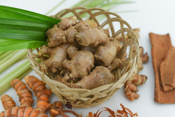 ginger, cinnamon, turmeric, galangal, pandan leaves, lemongrass on a white background