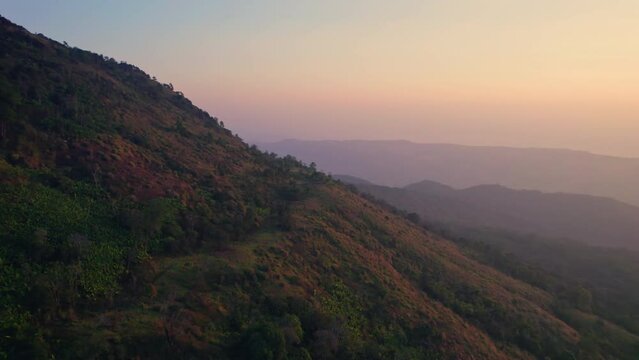 Colorful sunrise over mountain range in tropical rainforest at Phu Lom Lo, Phu Hin Rong Kla national park