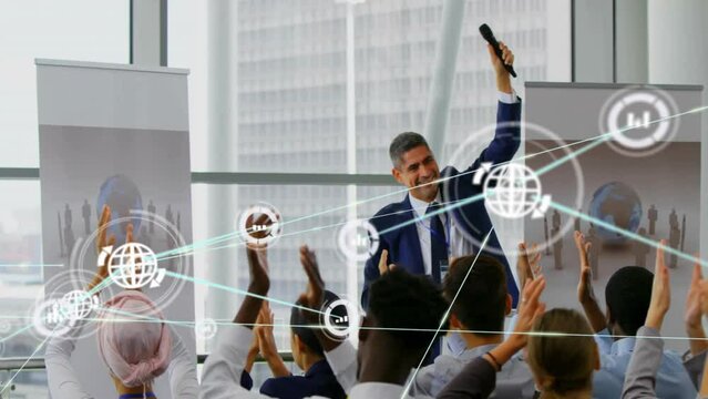 Animation of network of connections with icons over diverse colleagues at meeting clapping hands