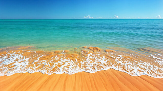 A serene coastal scene, with golden sands meeting the turquoise expanse of the ocean under a clear blue sky