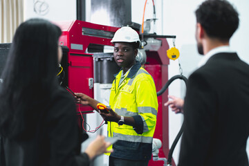 An African professional engineering is showing the process and how robotic that use in the factory or industry working, concept of futuristic manufacturing, innovation intelligence, invention success