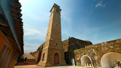 Ancient clock tower in fortress. Action. Beautiful sunny view of stone walls and clock tower in...