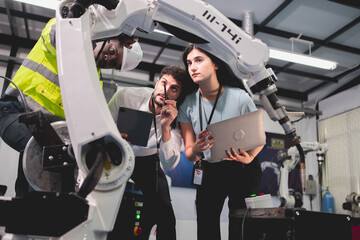 Professional smart robotic engineering team are working and discussing with robotic process or checking, concept of examining manufacturing innovation or invention, technician of futuristic automated.