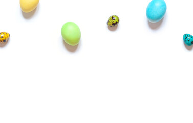 Colorful painted Easter eggs on the white background. Top view. Copy space