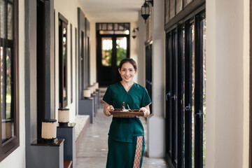 Portrait Asian woman professional masseuse prepare spa set for massage service customer in cosmetology spa centre.