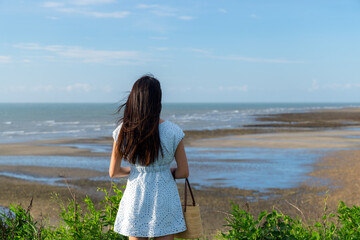 Back rear view of woman look at the sea beach