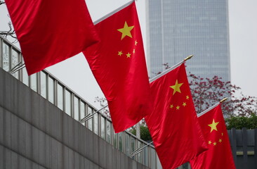 Flags of China flutter in the wind in the sky