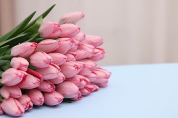 Bouquet of beautiful pink tulips on light grey background, closeup. Space for text