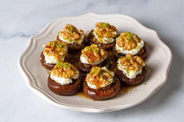 Stuffed dry fig dessert, cooked with syrup, traditional, pistachio and kaymak (Turkish name; kaymakli incir tatlisi )