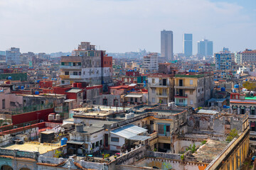 Central Havana (Centro Havana) aerial view with modern skyscrapers in Vedado at the background,...