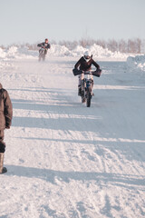 Young man Learning To Ride Enduro Motorbike In Winter. New hobby of a young man - enduro bike driving lesson with instructor