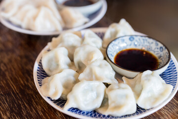 Meat dumpling with soy sauce on the table
