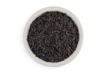 Black rice in a ceramic bowl isolated on white background. Top view. Flat lay