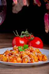 Gnocchi dish with sauce and wine