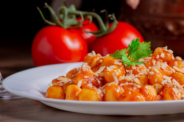 Gnocchi dish with sauce and wine