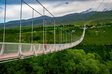 Fototapeta na wymiar Meshgin Shahr Suspended Bridge Over Verdant Valley in Ardabil, Iran