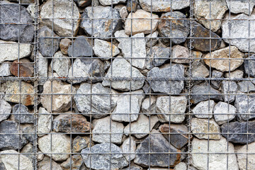 Close up gabion wall caged stones textured background