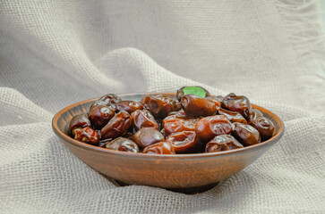 dried dates in a brown ceramic plate