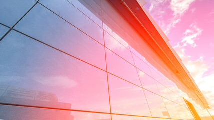 Wall of modern building with reflection of clouds