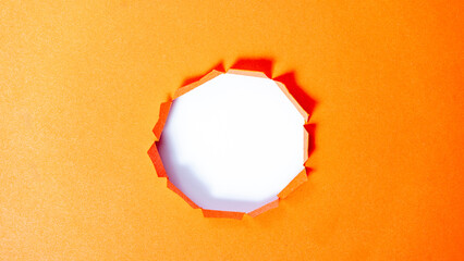 hole in Orange Color Ragged Edge paper mockup blank for design, Smooth hole edge, natural shade. Paper, pierce, hole, top angle, texture