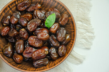 Dried dates in a ceramic plate, top view