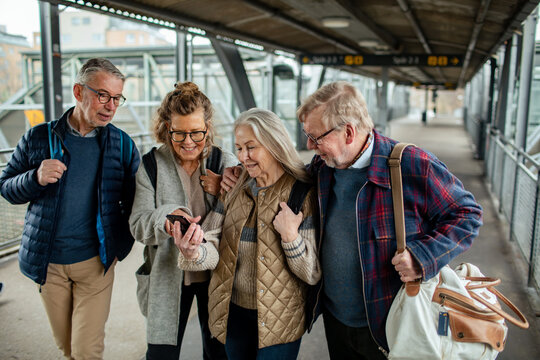 Group of senior people walking together at train station