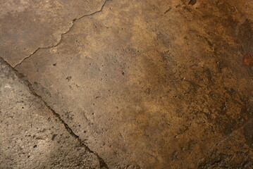 Building materials, wet concrete asphalt old after a rainstorm very bright brown background.
