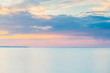 Cloudy Sky Over Large Body of Still Water