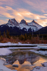 Winter sunset at The Three Sisters, a trio of peaks near Canmore, Alberta, Canada.