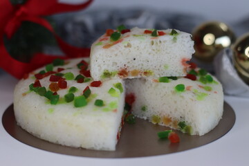 Vattayappam with tutti fruity, a Kerala sweet dish. Vattayappam is a steamed rice cake with coconut and yeast