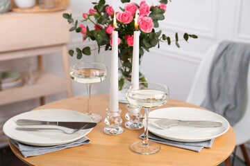 Romantic table setting with candles and flowers