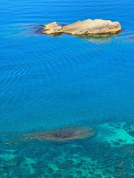 Rocks in the turquoise blue sea of Mediterranean coast.