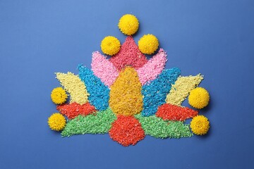 Diwali celebration. Colorful rangoli on blue background, top view