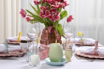 Festive table setting with beautiful flowers. Easter celebration